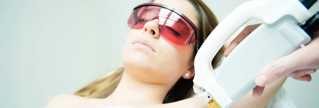 A woman is undergoing Laser Hair removal treatment in her armpit